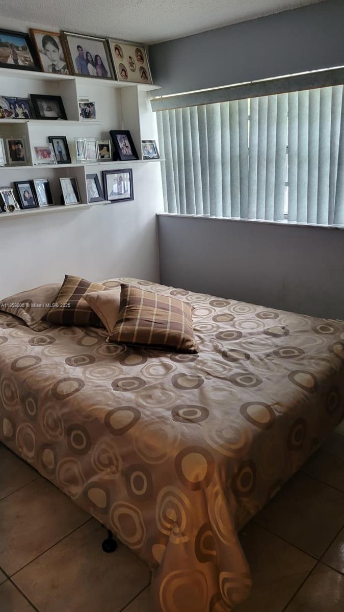 11472 Southwest 4th Street Sweetwater, FL 33174 - Photo 52 of 65 a bedroom with a bed and closet