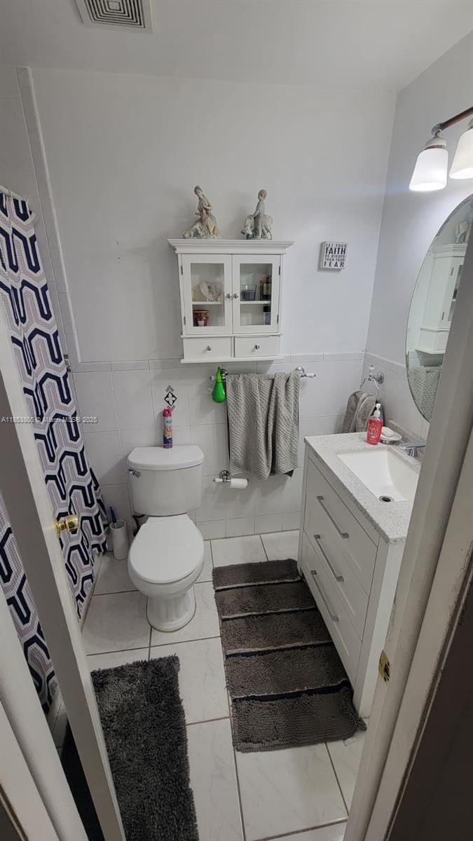 11472 Southwest 4th Street Sweetwater, FL 33174 - Photo 53 of 65 a bathroom with a sink toilet and a mirror