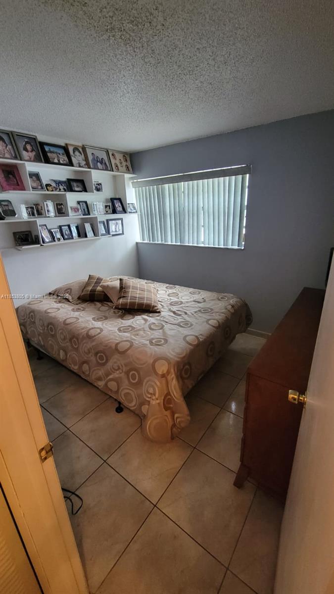 11472 Southwest 4th Street Sweetwater, FL 33174 - Photo 55 of 65 a bedroom with a bed and window