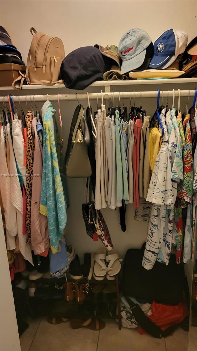 11472 Southwest 4th Street Sweetwater, FL 33174 - Photo 57 of 65 a view of walk in closet with clothes and shoes