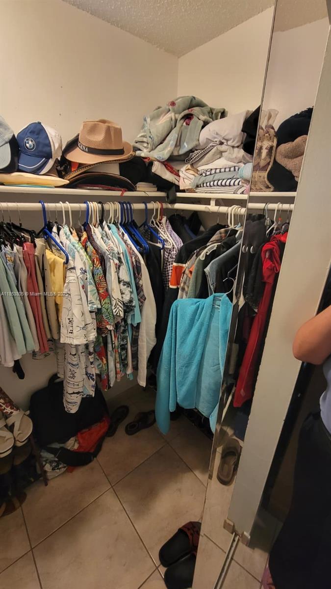 11472 Southwest 4th Street Sweetwater, FL 33174 - Photo 59 of 65 a view of walk in closet with clothes and shoes