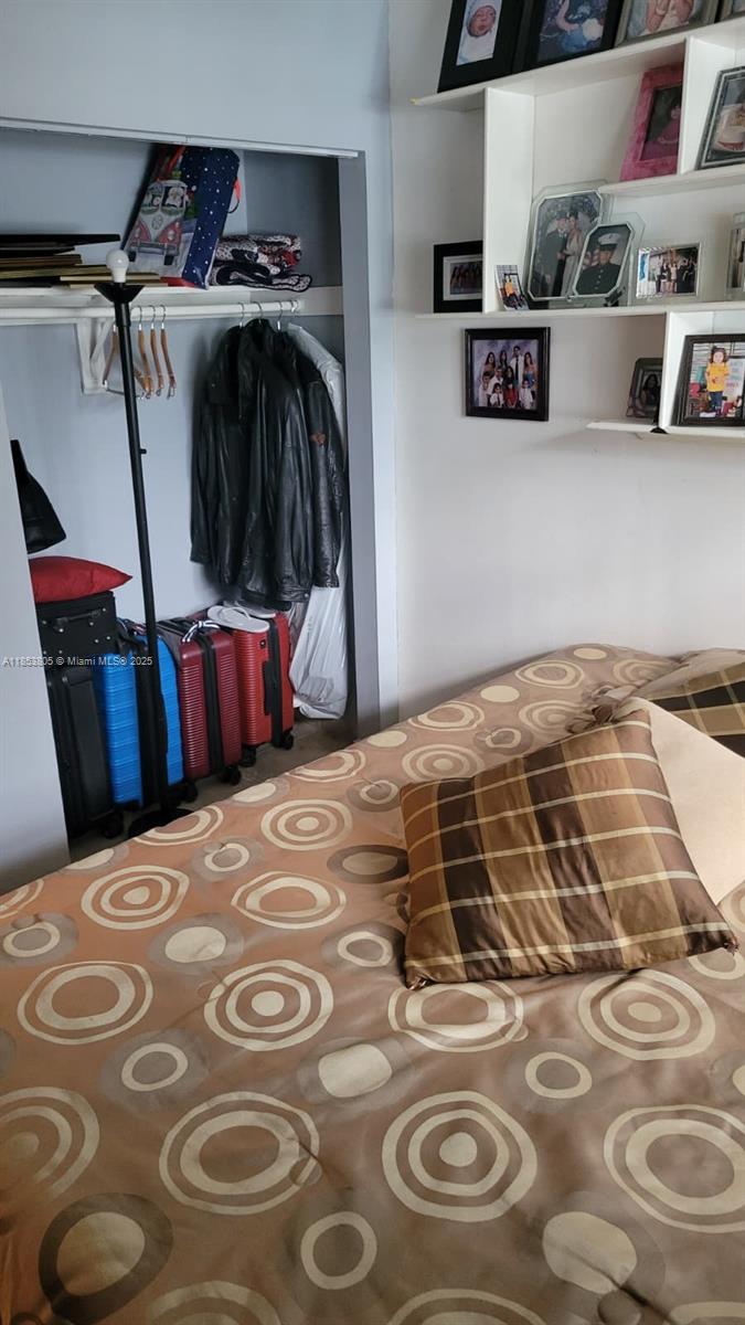 11472 Southwest 4th Street Sweetwater, FL 33174 - Photo 61 of 65 a bedroom with a bed and a mirror