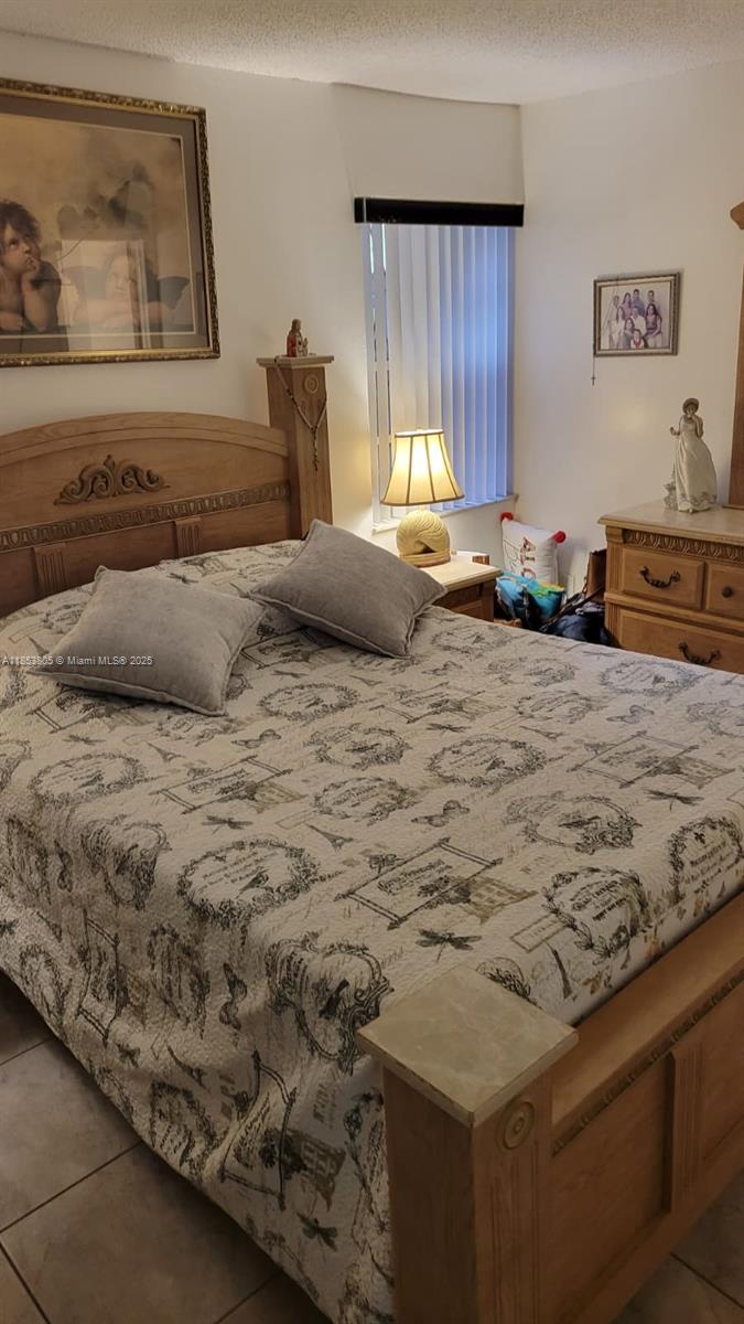 11472 Southwest 4th Street Sweetwater, FL 33174 - Photo 63 of 65 a bedroom with a bed and a dresser