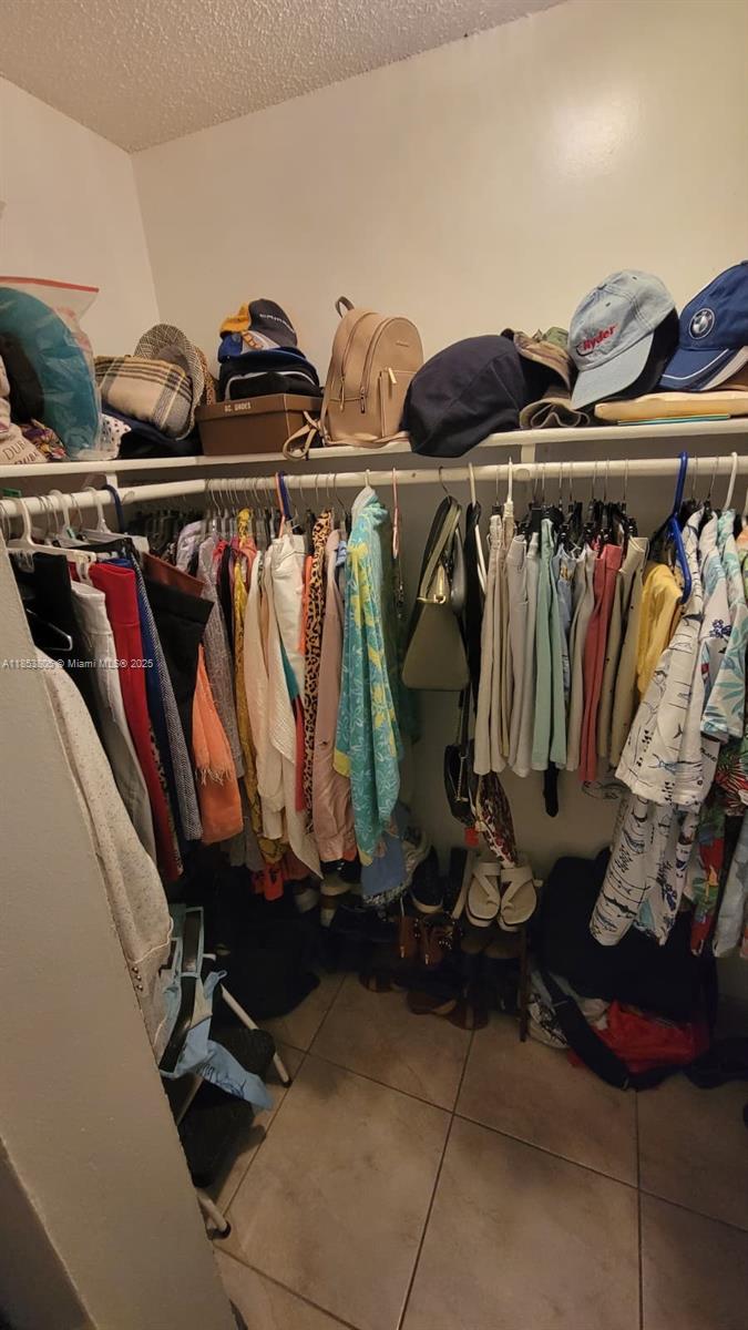 11472 Southwest 4th Street Sweetwater, FL 33174 - Photo 64 of 65 a view of walk in closet with clothes and shoes