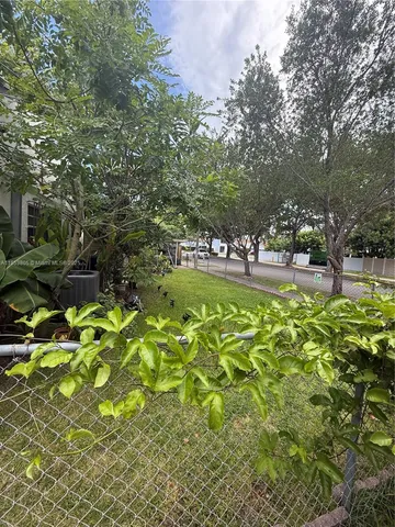 a view of a field of grass and trees