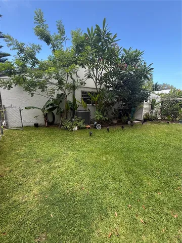 a room with a painting on the wall and a stove