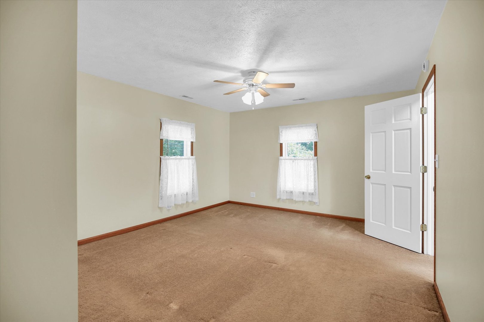 221 East 5th Avenue Rankin, IL 60960 - Photo 18 of 44 an empty room with windows and ceiling fan