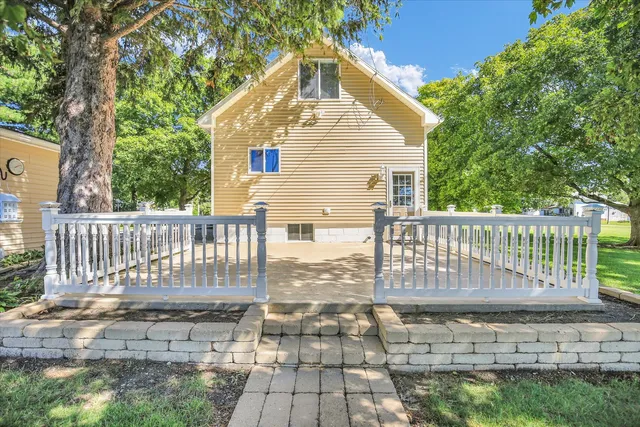 a view of a deck with a large window and wooden fence
