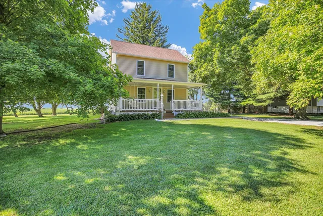 a front view of house with yard and green space