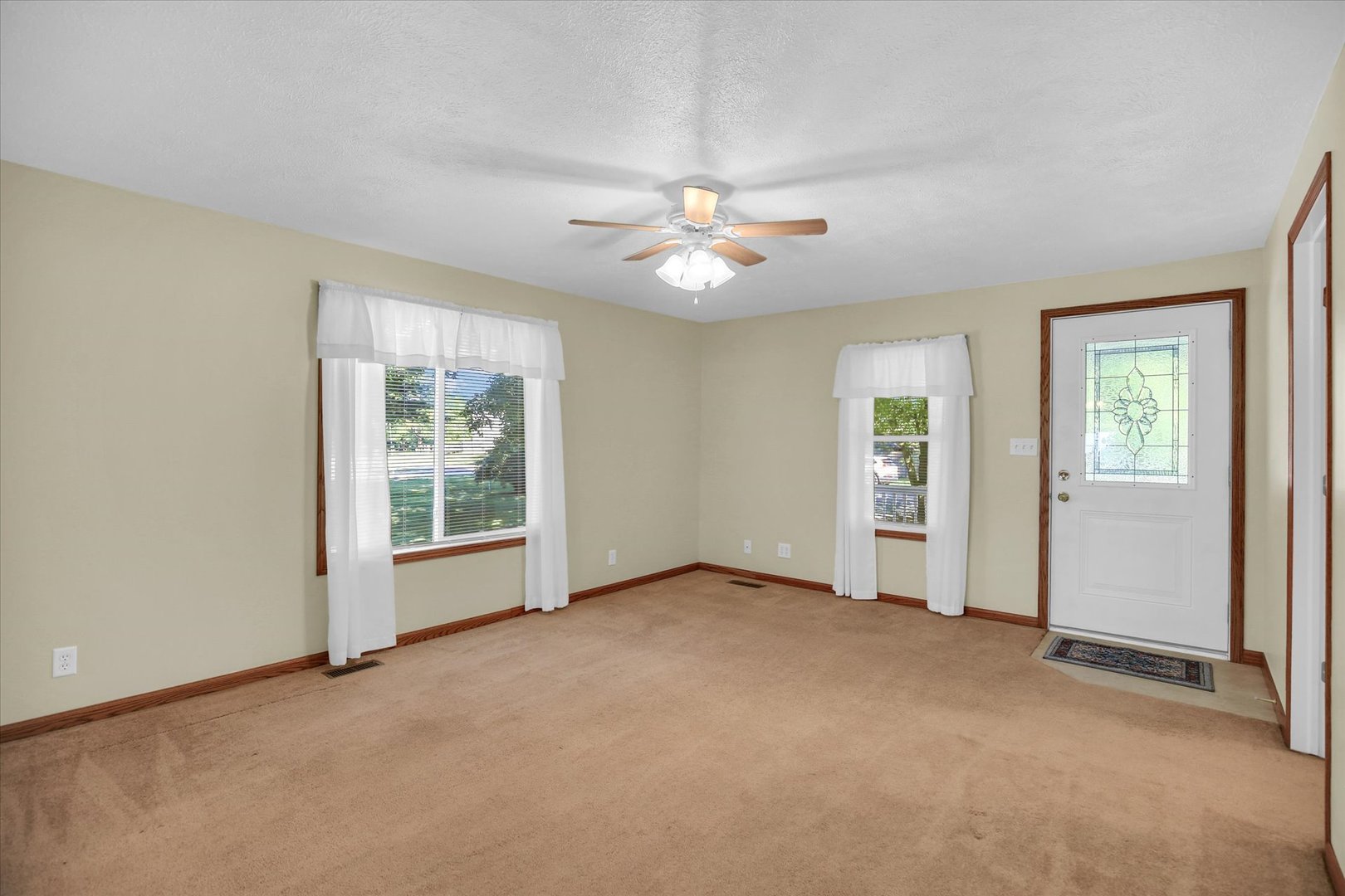 221 East 5th Avenue Rankin, IL 60960 - Photo 5 of 44 an empty room with windows and fan chandelier fan
