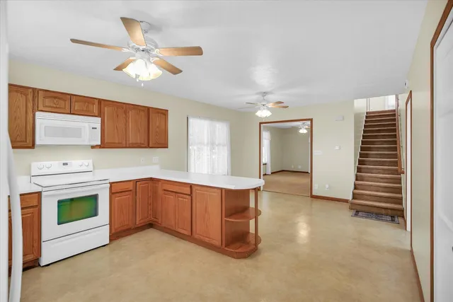 a view of a kitchen with a sink dishwasher and a fireplace