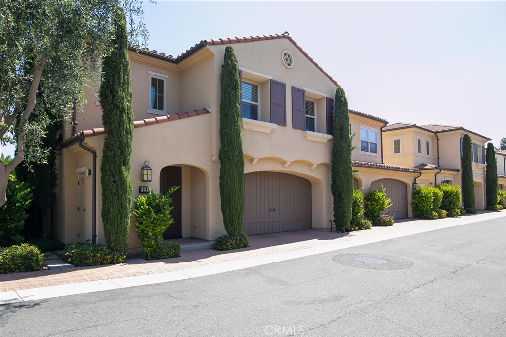 116 Gemstone Irvine, CA 92620 - Photo 2 of 3 a front view of a house with a yard and garage