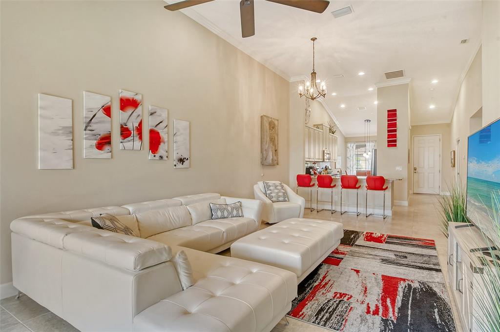 13604 Messina Loop, Unit 203 Bradenton, FL 34211 - Photo 11 of 56 a living room with furniture and a flat screen tv