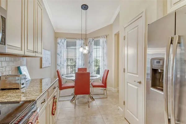 a kitchen with a sink dishwasher stove and white cabinets with wooden floor