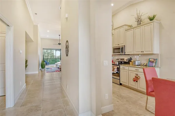 a kitchen with granite countertop a refrigerator and a sink