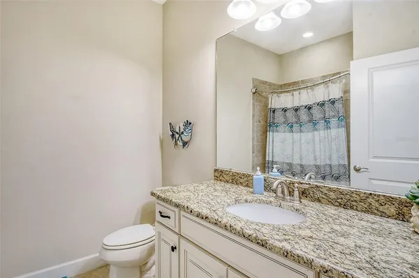 a front view of a house with a garden and trees