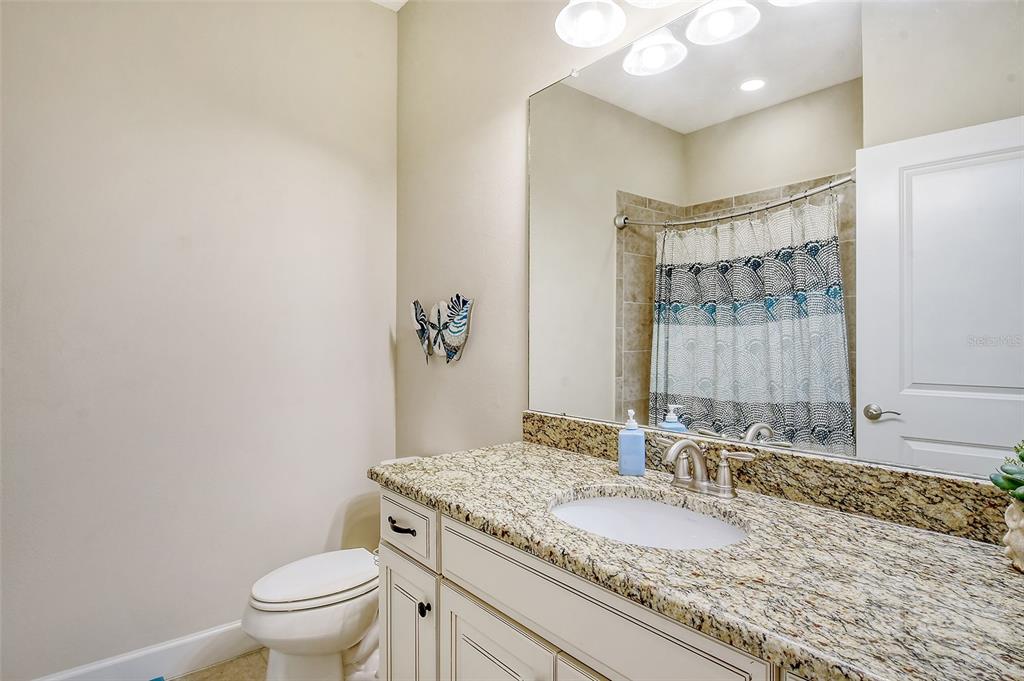 13604 Messina Loop, Unit 203 Bradenton, FL 34211 - Photo 28 of 56 a bathroom with a granite countertop sink a toilet and a mirror