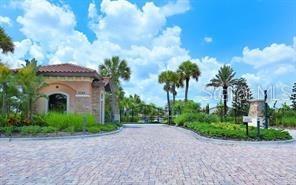 13604 Messina Loop, Unit 203 Bradenton, FL 34211 - Photo 31 of 56 a front view of a house with a garden and trees