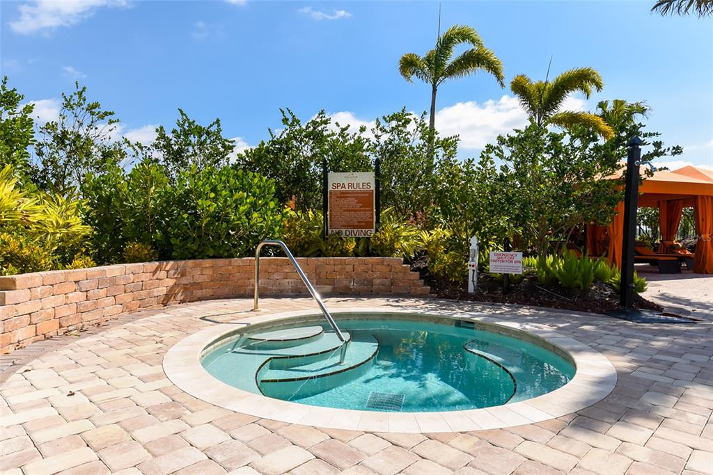 13604 Messina Loop, Unit 203 Bradenton, FL 34211 - Photo 39 of 56 a swimming pool with outdoor seating and plants