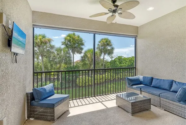 a living room with furniture tv and a window