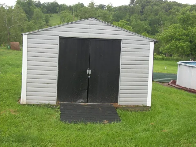 a view of a small house with a yard