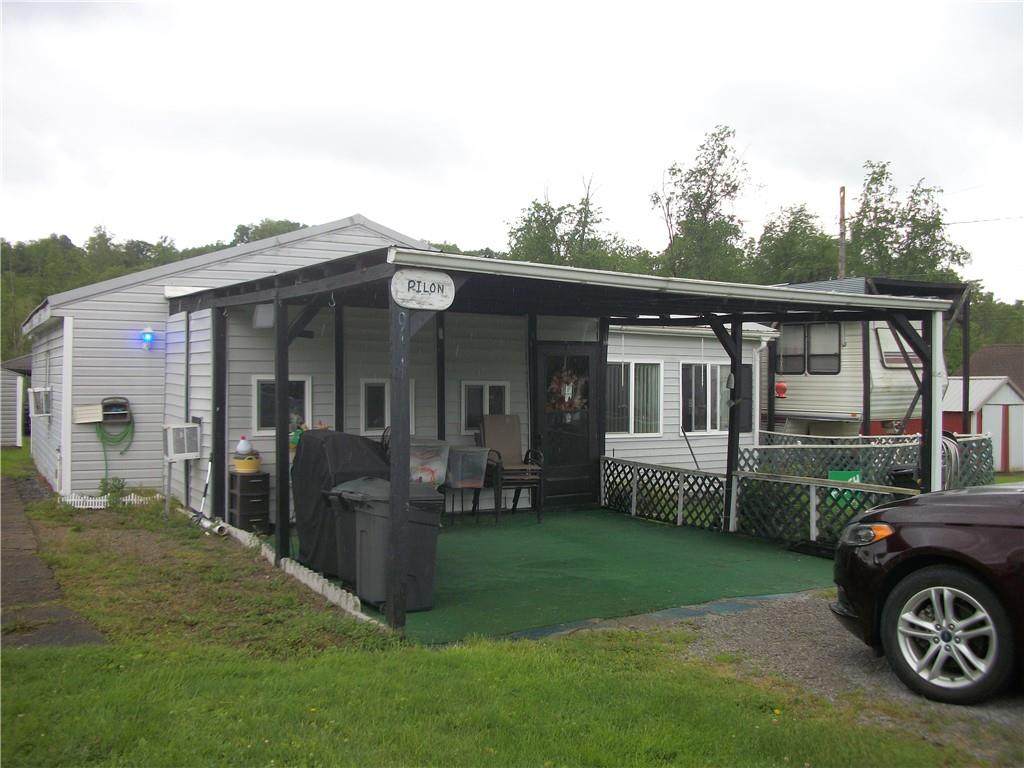 944 Mapletown Road Greensboro, PA 15338 - Photo 2 of 20 a front view of a house with a garden and porch