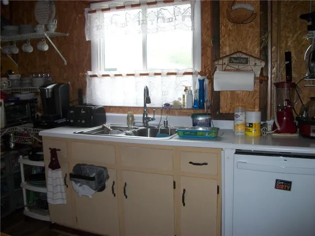 a kitchen with a sink cabinets and a window