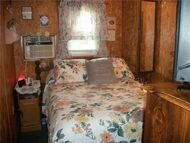 a bed sitting in a bedroom next to a window