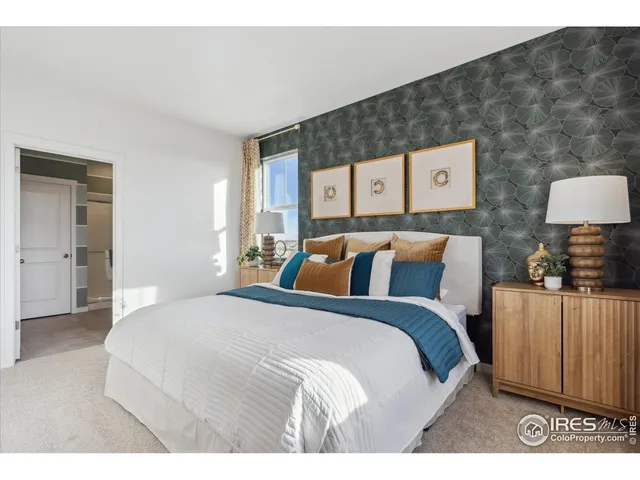 a bedroom with a bed and a night stand