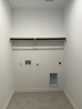 a view of an empty room with brick wall and windows