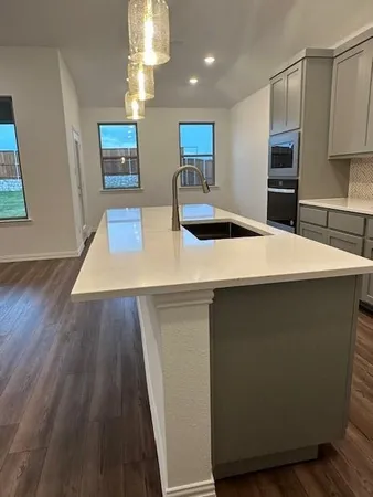 a stove top oven sitting inside of a kitchen