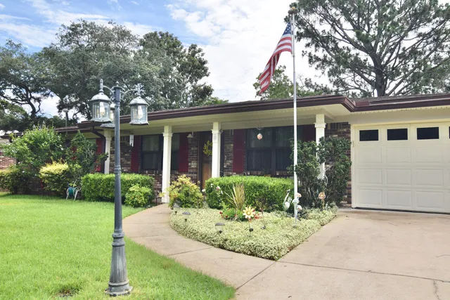 a front view of a house with garden