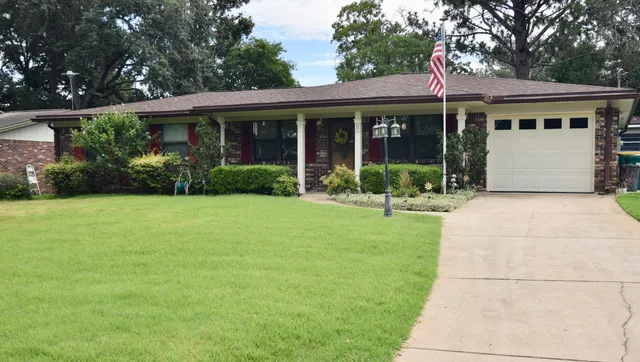 a front view of a house with garden and porch