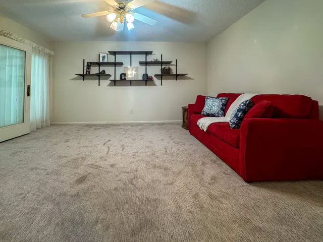 a bathroom with a sink a toilet a mirror and shower