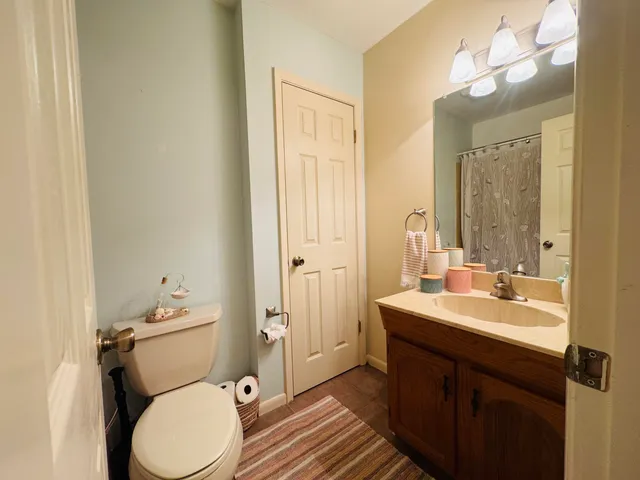 a bathroom with a granite countertop sink toilet and shower