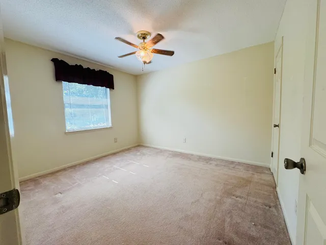 a view of a storage room with furniture and a rug