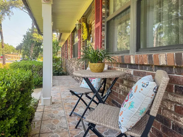 a view of a patio with table and chairs and potted plants