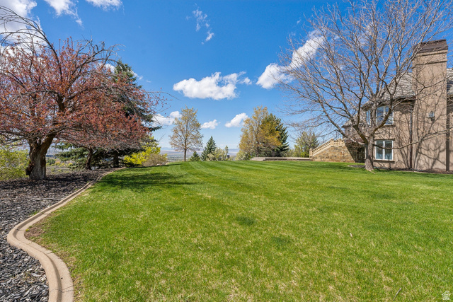 1714 Ridge Point Drive Bountiful, UT 84010 - Photo 103 of 132 Expansive lawn featuring mature trees and a stone-clad exterior