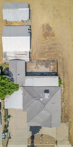 a view of a house with a yard and large tree