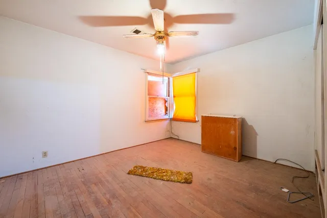 a view of a livingroom with a ceiling fan and window
