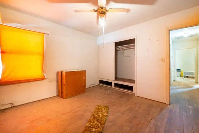 a front view of a house with a yard and potted plants