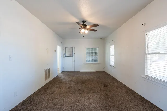 a view of a big room with closet and chandelier fan