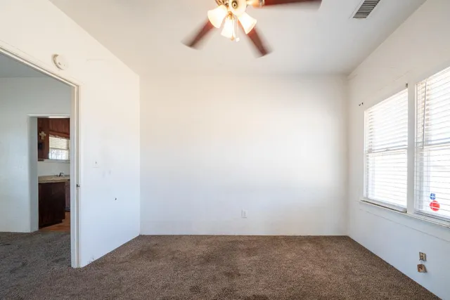 a kitchen with refrigerator and cabinets