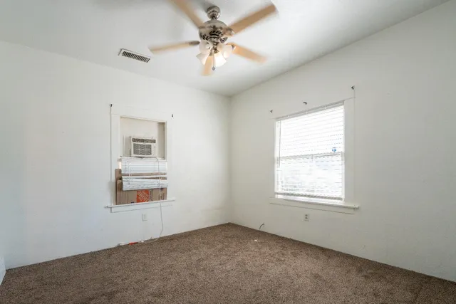 a kitchen with stainless steel appliances a refrigerator sink and white cabinets