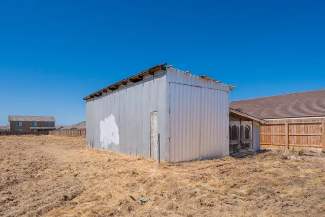 a kitchen with stainless steel appliances granite countertop sink stove and white cabinets with wooden floor