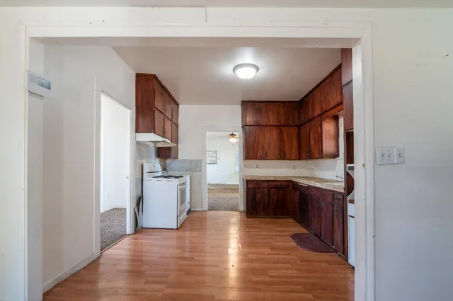 a view of an empty room with window and a livingroom