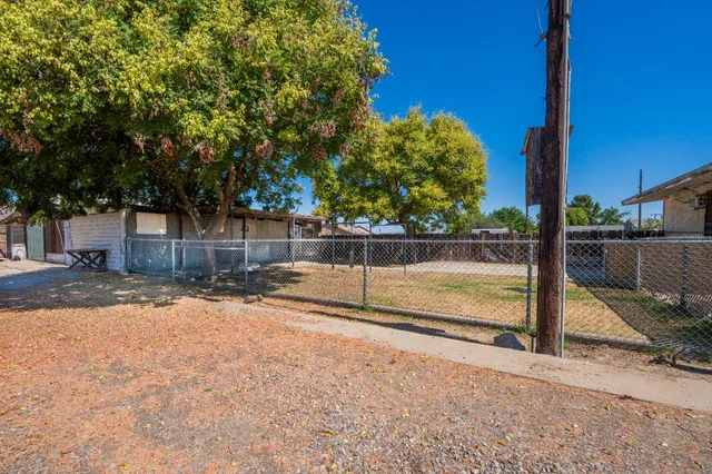 a view of a house with a tree and yard