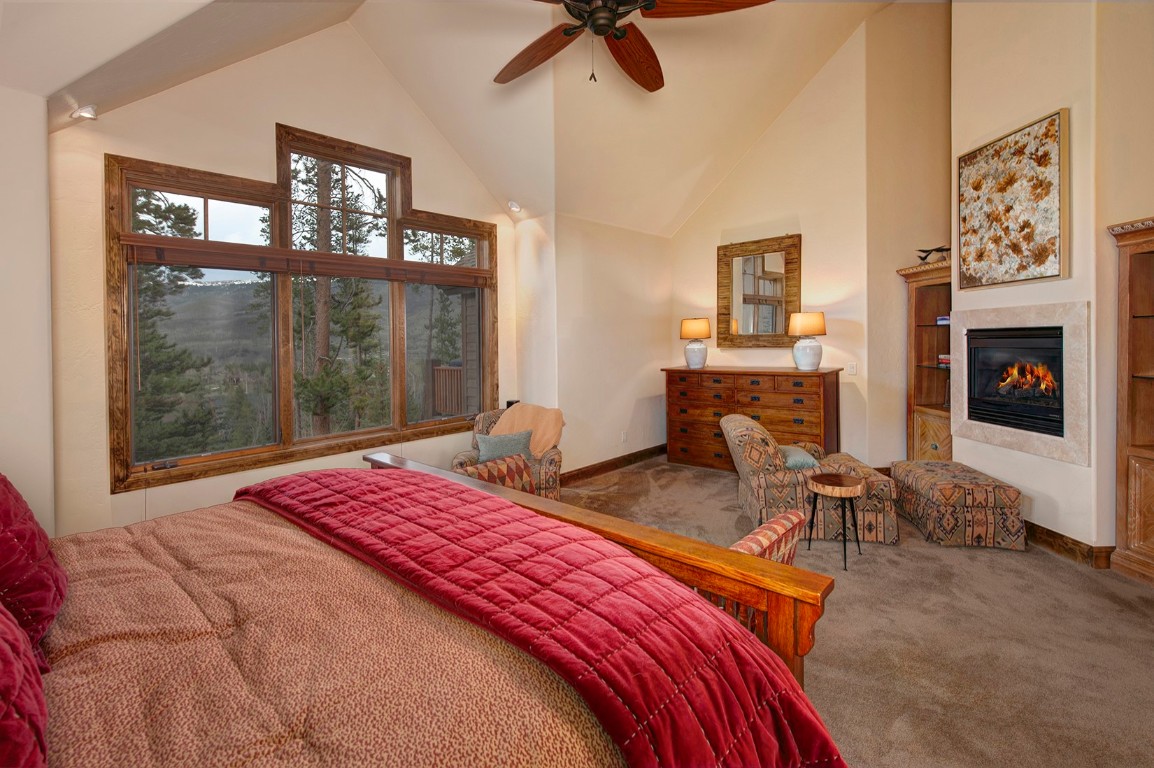 724 Willowbrook Road Silverthorne, CO 80498 - Photo 15 of 30 a bedroom with a bed and a fireplace