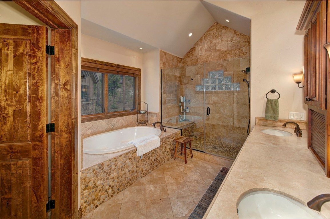 724 Willowbrook Road Silverthorne, CO 80498 - Photo 18 of 30 a spacious bathroom with a tub shower and mirror