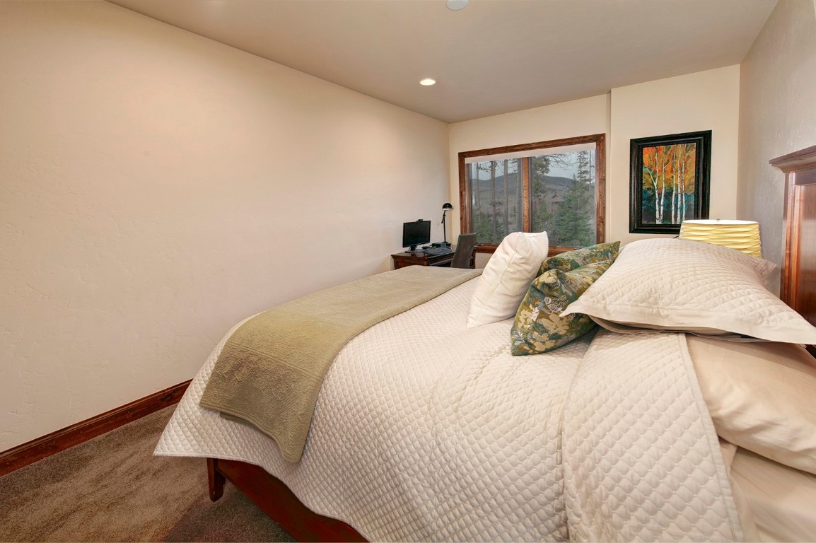 724 Willowbrook Road Silverthorne, CO 80498 - Photo 25 of 30 a bed sitting in a bedroom next to a window